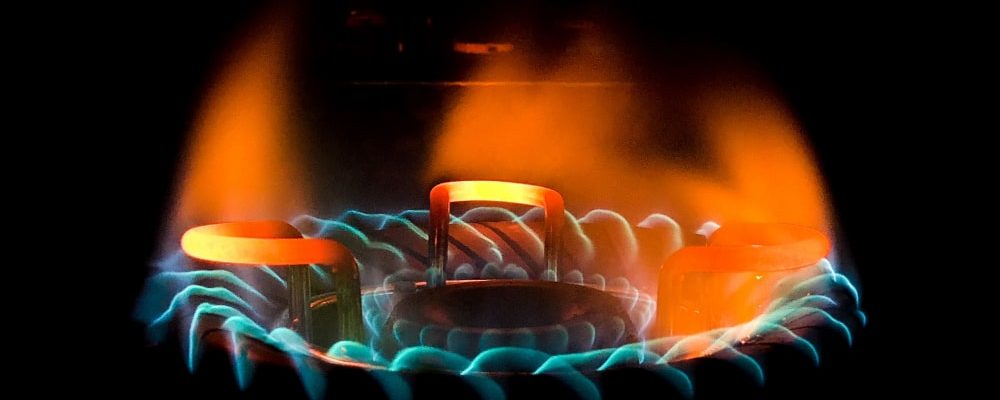 closeup-shot-of-a-beautiful-blue-green-flame-in-a-gas-stove-min